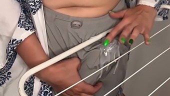 Mature Stepmother Teases Her Stepson With Her Large Penis While Doing Laundry
